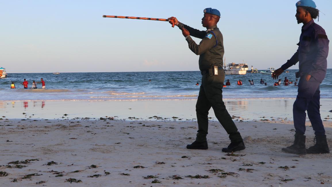 SOMALIA-HEALTH-VIRUS A Somali police officer gestures with his stick while he disperses people from the Lido beach in Mogadishu, Somalia, on April 4, 2020 enforcing a ban on public gathering to curb the spread of Covid-19 coronavirus. - Somali government on Saturday confirmed two more cases of Coronavirus with total number reaching to seven. (Photo by Abdirazak Hussein FARAH / AFP) (Photo by ABDIRAZAK HUSSEIN FARAH/AFP via Getty Images)