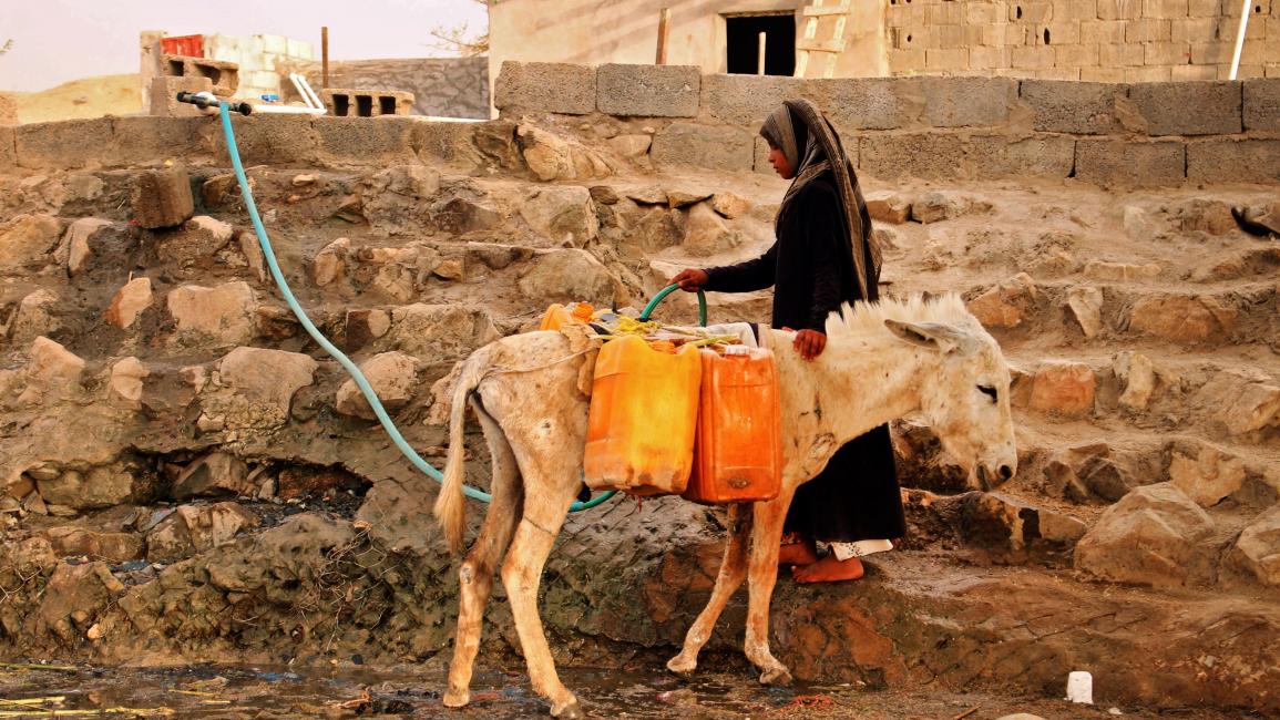 TOPSHOT-YEMEN-CONFLICT-WATER TOPSHOT - A displaced Yemeni woman from Hodeida fills water containers at a make-shift camp in a village in the northern district of Abs in the country's Hajjah province, on May 9, 2019. - The Yemeni conflict has triggered what the United Nations describes as the world's worst humanitarian crisis, with 3.3 million people still displaced and 24.1 million in need of aid. (Photo by ESSA AHMED / AFP) (Photo credit should read ESSA AHMED/AFP via Getty Images)