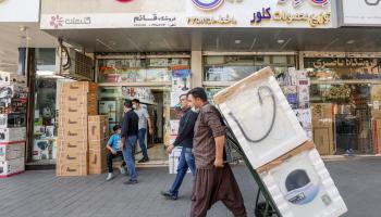 An Iranian moves appliances in the Amin hozur bazaar in Tehran on October 3,2021. - Late last month, Iran's President Ebrahim Raisi banned the import of household appliances from South Korea, on instruction from supreme leader Ayatollah Ali Khamenei, who said the imports could harm local production. But South Korean appliances are still in high demand, despite the ban. (Photo by ATTA KENARE / AFP) (Photo by ATTA KENARE/AFP via Getty Images)