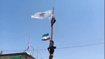 محتج ينزل علم الائتلاف من مقره بمدينة أعزاز (فيسبوك)