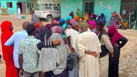 سودانيون نازحون ينتظرون في طابور للحصول على مساعدات (فرانس برس)